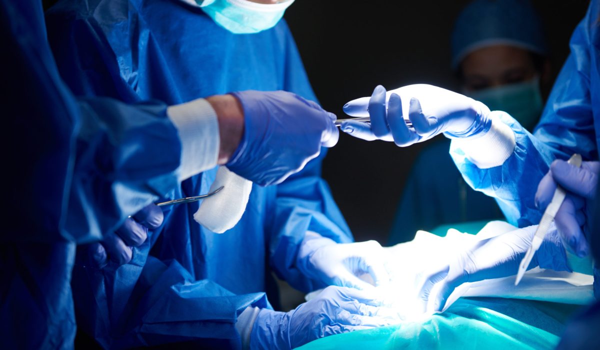 Surgeons passing scissors to each other